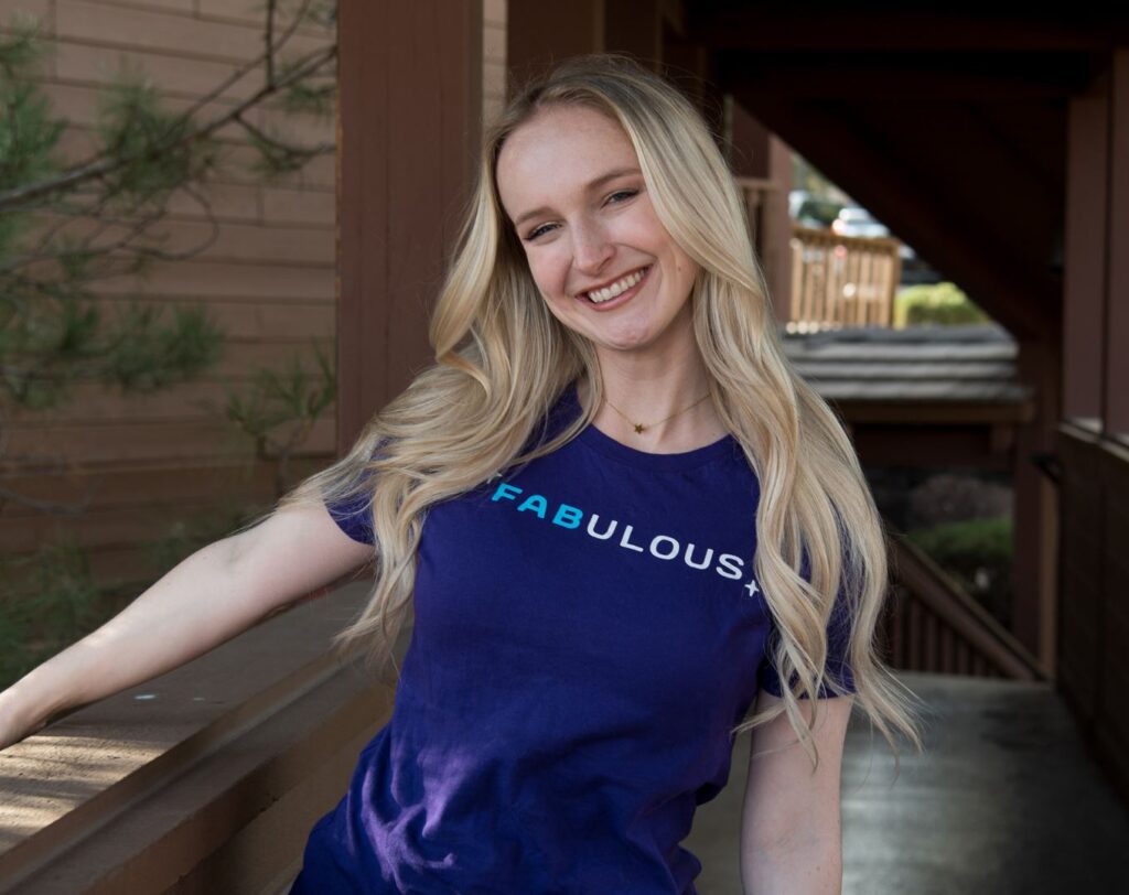 Camille wearing Orbit Fab purple shirt that says FABulous