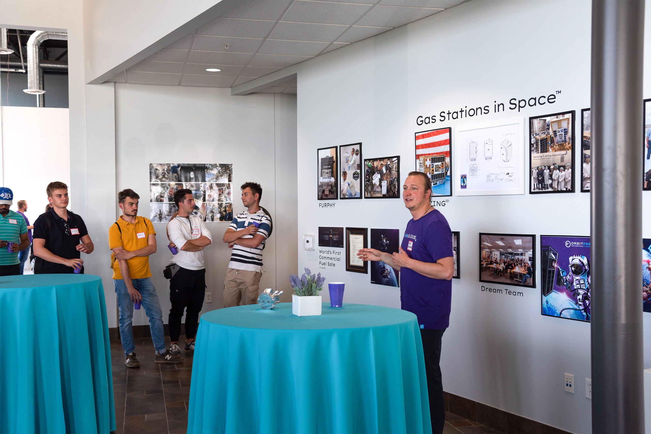 Image of James Bultitude in front of photo wall in our Colorado lobby during open house event