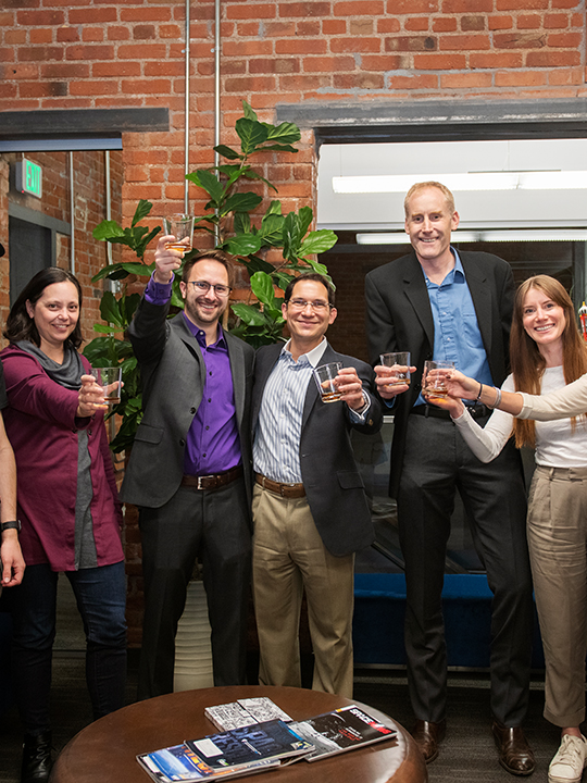 Group photo of Astroscale and Orbit Fab teammembers happily toasting to the fuel sale deal.