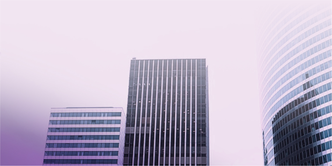 3 tall buildings with a purple gradient hue over them