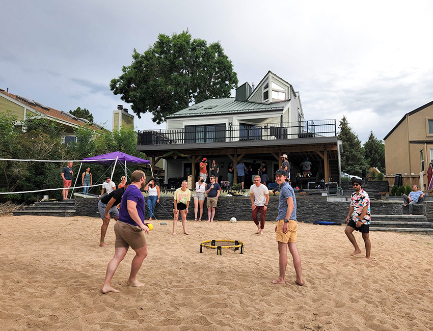 Image at Christmas in July party of Orbit Fab'ers playing volleyball
