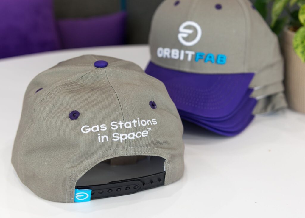 Orbit Fab hat picture with grey hat and purple bill and logo and Gas Stations In Space written on the back